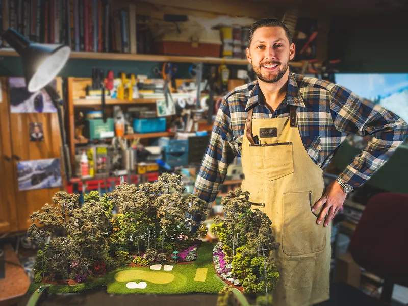 sam-in-workshop-with-golf-course-replica-thumb Sam in workshop with golf course replica