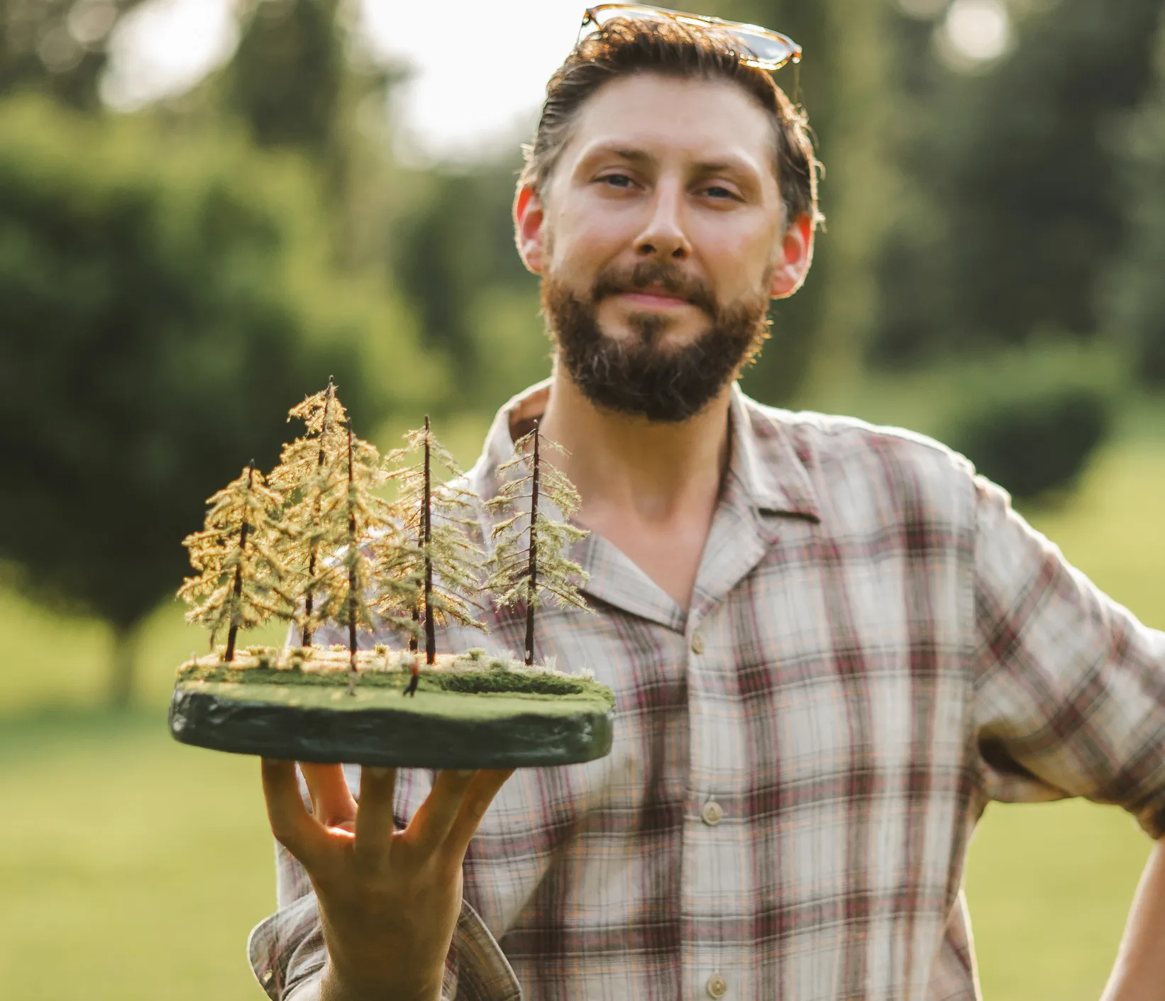 sam-holding-micro-landscape-tree-scene Sam holding micro landscape of tree scene mobile