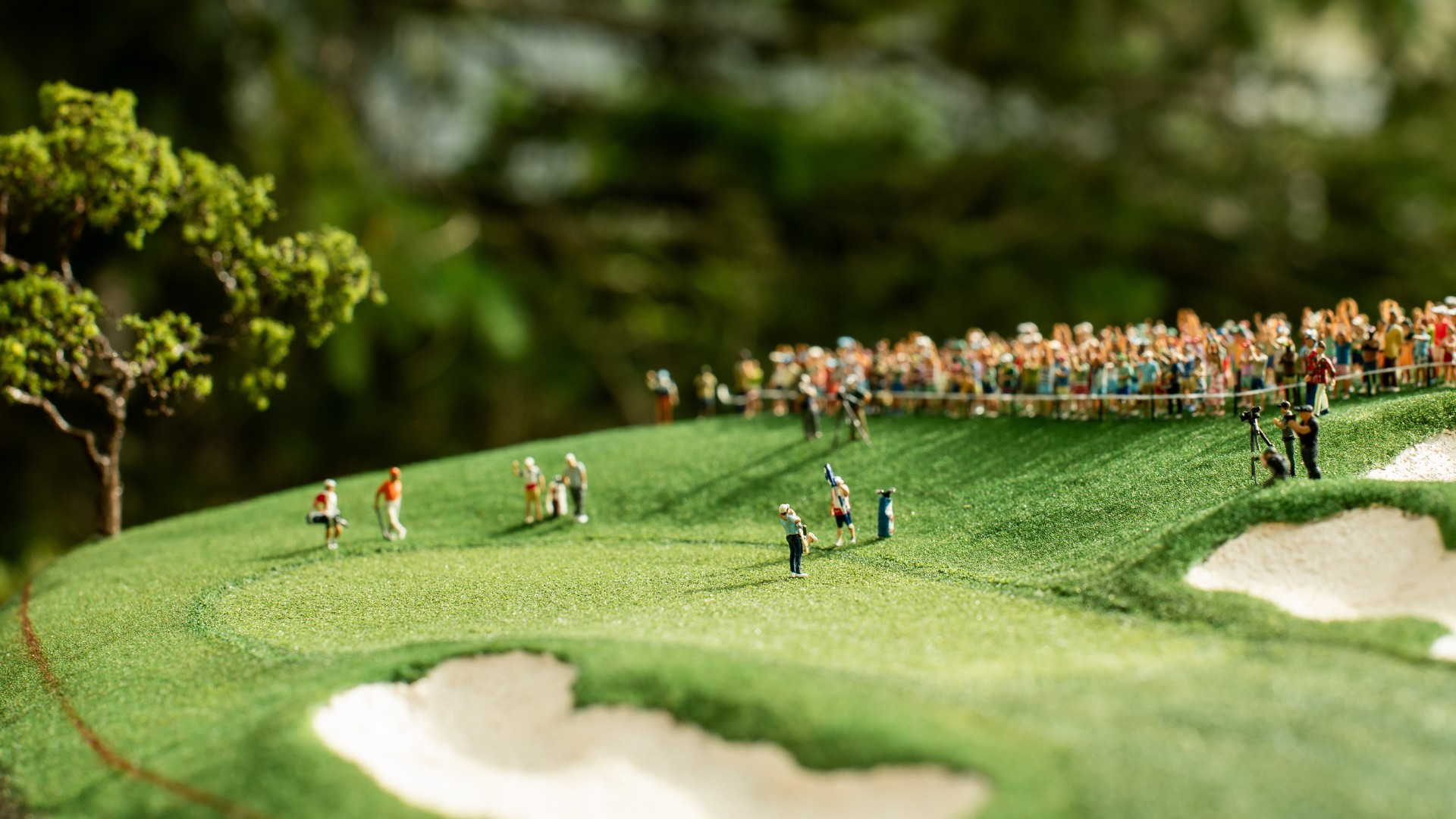 Miniature golfers approaching the 18th green during a recreated championship moment