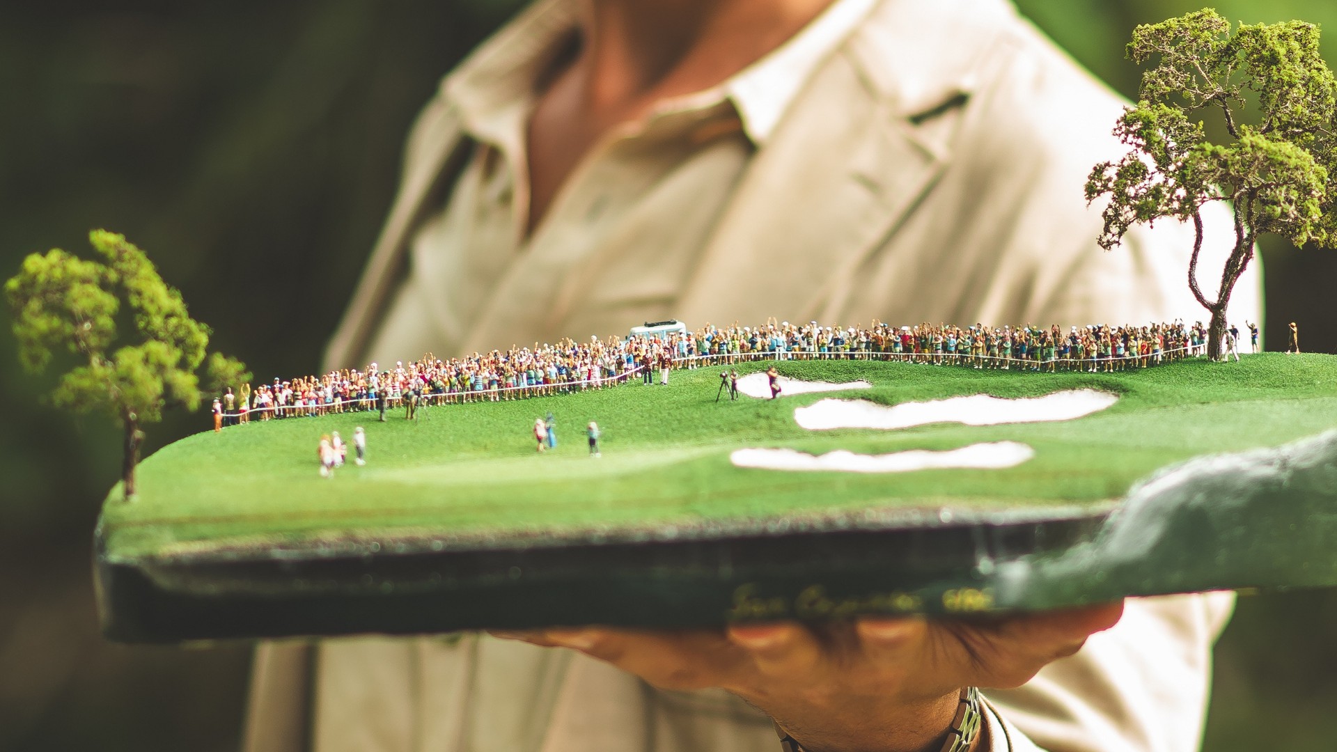 Micro landscape artist displaying a handcrafted golf course replica celebrating a PGA Tour victory