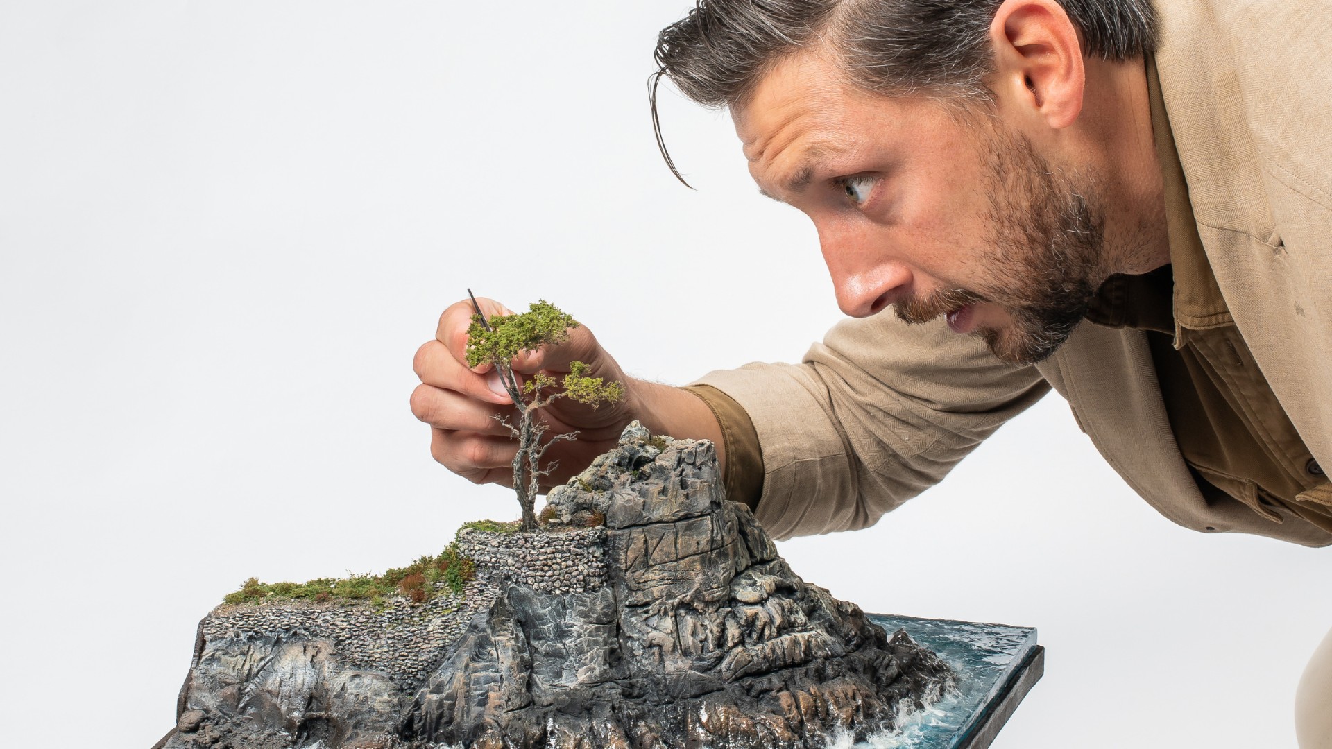 Miniature Monterey Cypress tree overlooking handcrafted coastal cliffs and ocean waters with micro landscape architect